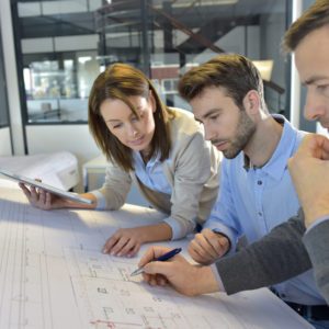 Drywall team members looking over plans